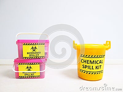 Chemical Spill kit yellow bucket and Biohazard Spill Kit with Warning danger caution hazard tag sign or symbol for emergency case. Stock Photo