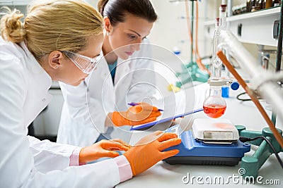 Chemical technicians working on experiment in laboratory Stock Photo