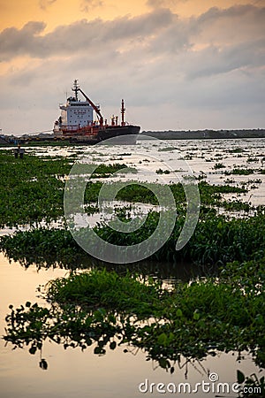 Chemical tanker docked in the Magdalena River at sunset. Colombia. Stock Photo