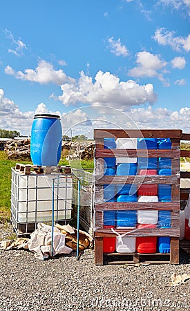 Chemicals in plastic containers at a dump site Stock Photo