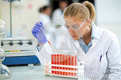 Chemist taking sample with pipette Stock Photo