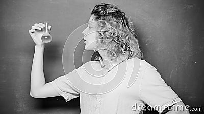 Chemistry lab. Woman teacher performing experiment with bulb and liquid. Interesting and fascinating. Explore chemistry Stock Photo