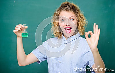 Chemistry lesson. Woman teacher performing experiment with bulb and liquid. Chemistry lab. Interesting and fascinating Stock Photo