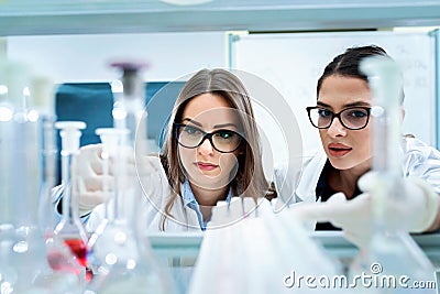 Young female researchers conducting laboratory test Stock Photo