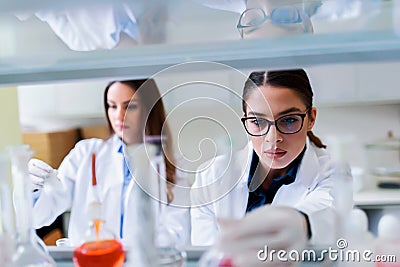 Young female researchers conducting laboratory test Stock Photo