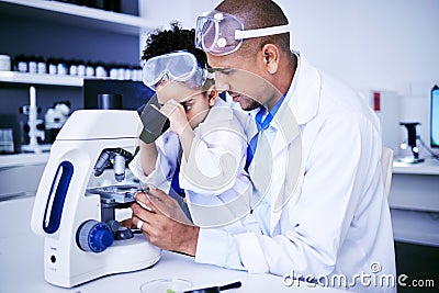 Chemistry, microscope and father with child in laboratory for medical research, science and education. Healthcare Stock Photo