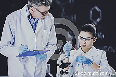 Chemistry Professor Controls Student. Stock Photo