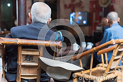 Senior chinese people watching TV in an old tearoom Editorial Stock Photo