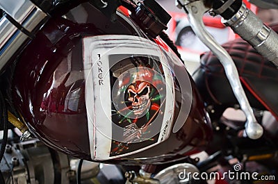 Custom motorcycle fuel tank close up with Joker game card Editorial Stock Photo