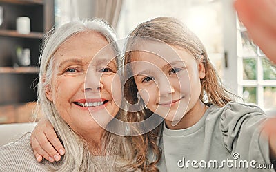 We cherish every visit. a little girl taking a selfie with her grandma at home. Stock Photo