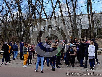 A large group of tourists in front of an old abandoned building. People of different ages and Editorial Stock Photo