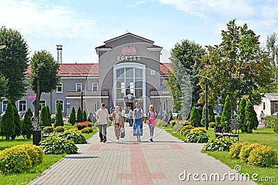 CHERNYAKHOVSK, RUSSIA. People walk along Privokzalnaya Square in the background of the railway station. Russian text - station Editorial Stock Photo