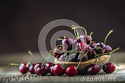 Cherries. Fresh sweet cherries. Delicious cherries with water drops in retro bowl on old oak table Stock Photo