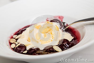 Cherries Jubilee Garnished with Sliced Almonds Stock Photo