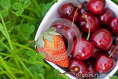 Cherries and strawberry in a ceramic bowl Stock Photo