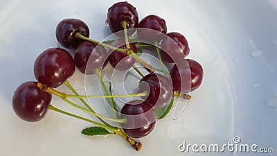 Cherry berries on a white porcelain plate Stock Photo