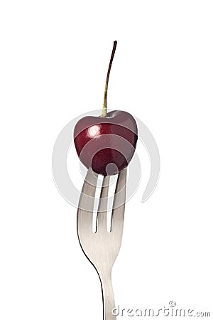 Cherry held by a fork Stock Photo