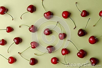 Cherry pattern. Flat lay of cherries and leaves on a blue background.Top view Stock Photo
