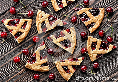 Cherry pie pieces on textured wooden background Stock Photo