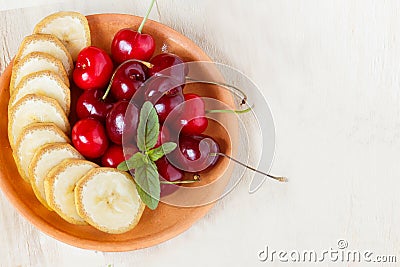 Cherry and sliced banana on a plate. Stock Photo