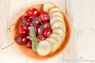 Cherry and sliced banana on a plate. Stock Photo