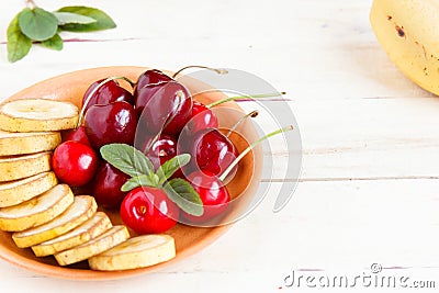 Cherry and sliced banana on a plate. Stock Photo