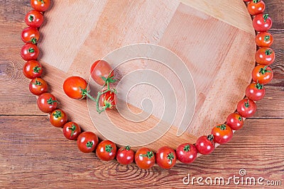 Top view of cherry tomatoes on wooden serving board, background Stock Photo