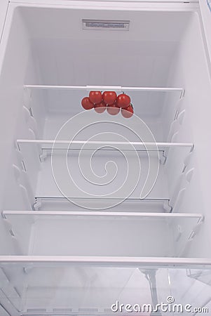 Cherry tomatoes in open empty refrigerator. Stock Photo