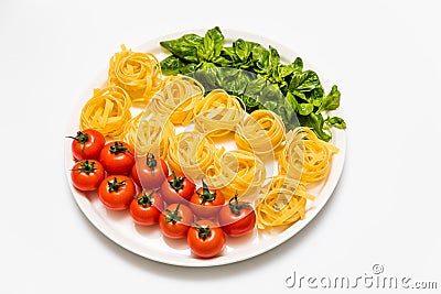 Cherry tomatoes, spaghetti and fresh basil on a platter on a white background Stock Photo