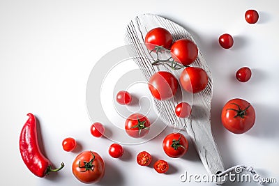 Cherry tomatoes, tomatoes on a branch, pepper, stand on a white Stock Photo