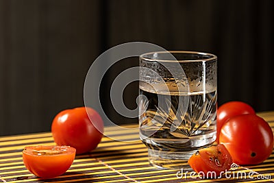 Cherry tomatoes and vodka on the mat home style Stock Photo