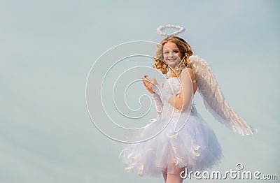 Cherub angel pray. The God of Love. Portrait of little curly blond Angel girl. Love card. Angel child girl with curly Stock Photo