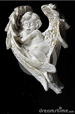 Cherub asleep black backgrounds Stock Photo