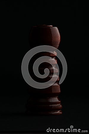 Chess. Black Rook on black background. Stock Photo