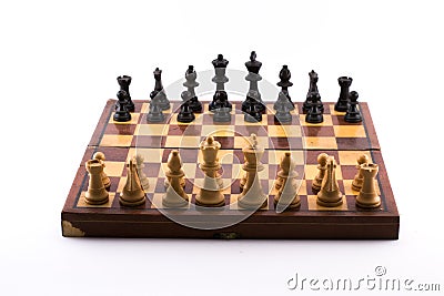 Chess board with black and white figurines on a white background Stock Photo