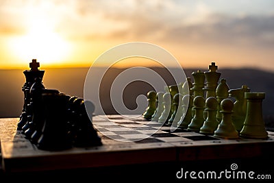 chess board game concept of business ideas and competition and strategy ideas. Chess figures on a chessboard outdoor sunset backgr Stock Photo