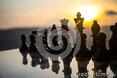 chess board game concept of business ideas and competition and strategy ideas. Chess figures on a chessboard outdoor sunset backgr Stock Photo