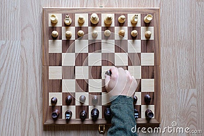 Chess board game. A hand playing chess. The fight begin. Business strategy and competition concept. Top view. Flat lay Stock Photo