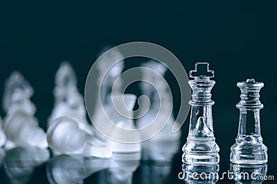 Chess business concept of victory. Chess figures in a reflection of chessboard. Game. Competition and intelligence concept. Stock Photo