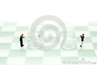 Chess business with miniature people : businessman idea for com Stock Photo