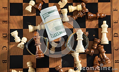 Chess figures and dollar money on the chessboard Stock Photo