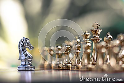 Chess game. A knight stand determinedly among the enemies. Business competitive concept Stock Photo