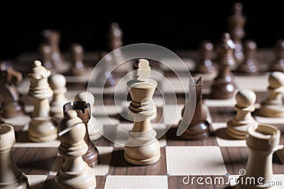 Chess game. White and black pieces are fighting for victory. The Central figure is in focus. Stock Photo