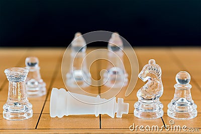 Chess glass on a wood chessboard Stock Photo