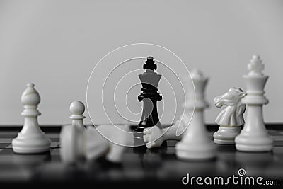 Chess King stand surrounded by enemies. The winner in business competition. Competitiveness and strategy Stock Photo