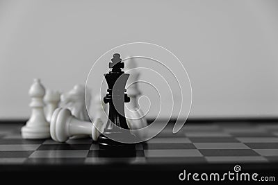 Chess King stand surrounded by enemies. The winner in business competition. Competitiveness and strategy Stock Photo