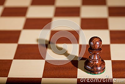Chess piece - a black pawn on a chessboard. Stock Photo