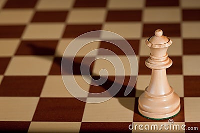 Chess piece - a white queen on a chessboard. Stock Photo