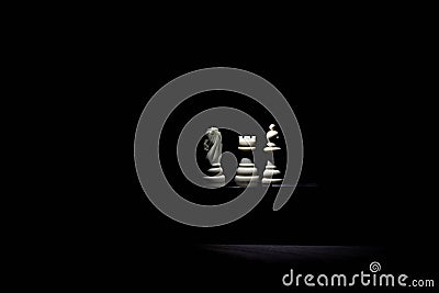 Chess pieces under the light in the dark Stock Photo