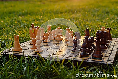 Chessboard and chess pieces on the grass in the garden Stock Photo